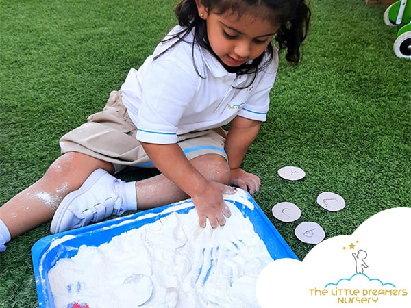 writing on flour a good preschool activity