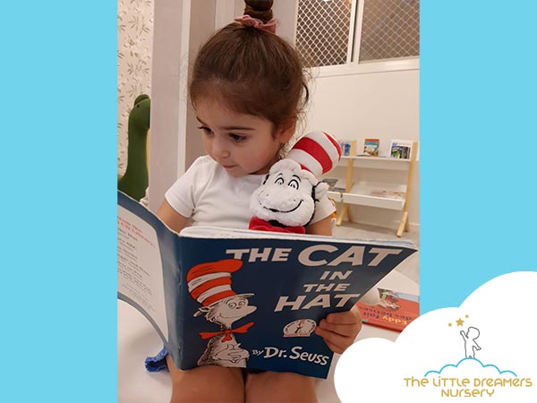  a-cute-girl-is-reading-a-story-book-in-a-british-nursery-in-dubai
