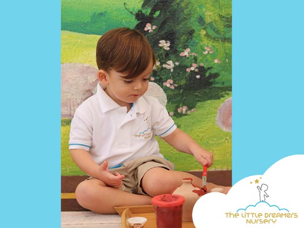 a boy is painting in nursery