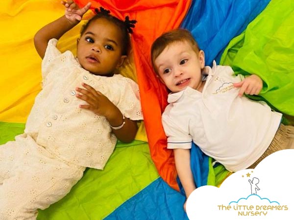 two cute children are playing in a nursery